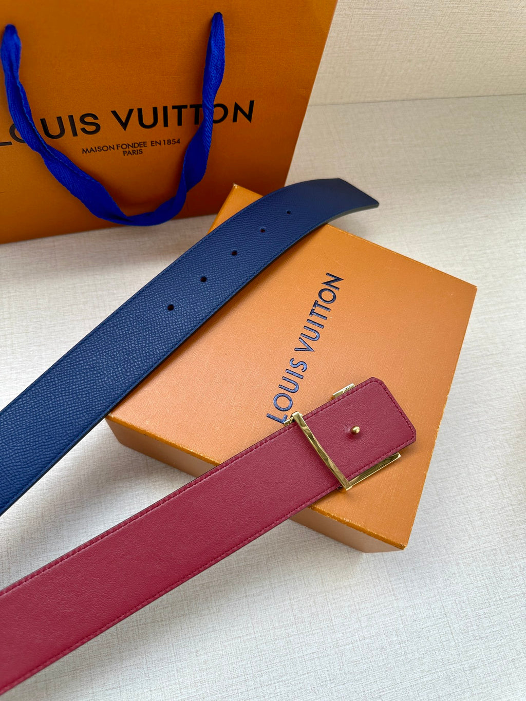 Louis Vuitton belt straps, navy blue and magenta, with small charm on boxes