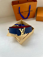 Louis Vuitton belt with navy blue strap and gold-tone LV buckle, in open box