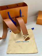 Louis Vuitton belt on fabric pouch, tan strap with gold LV buckle and embossed pattern
