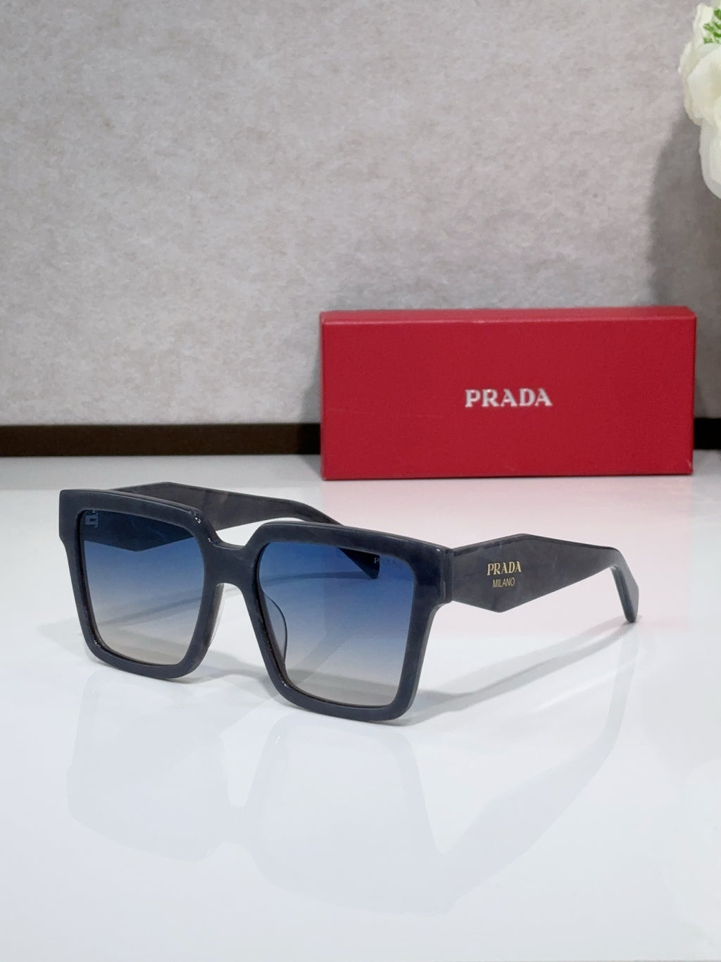 Prada navy blue square sunglasses with thick acetate frames and tinted lenses