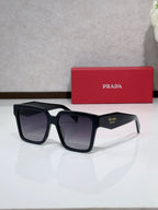 Prada black square sunglasses with thick acetate frames and dark gradient lenses