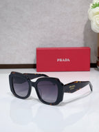 Prada sunglasses, black frame with dark tinted lenses and angled arms
