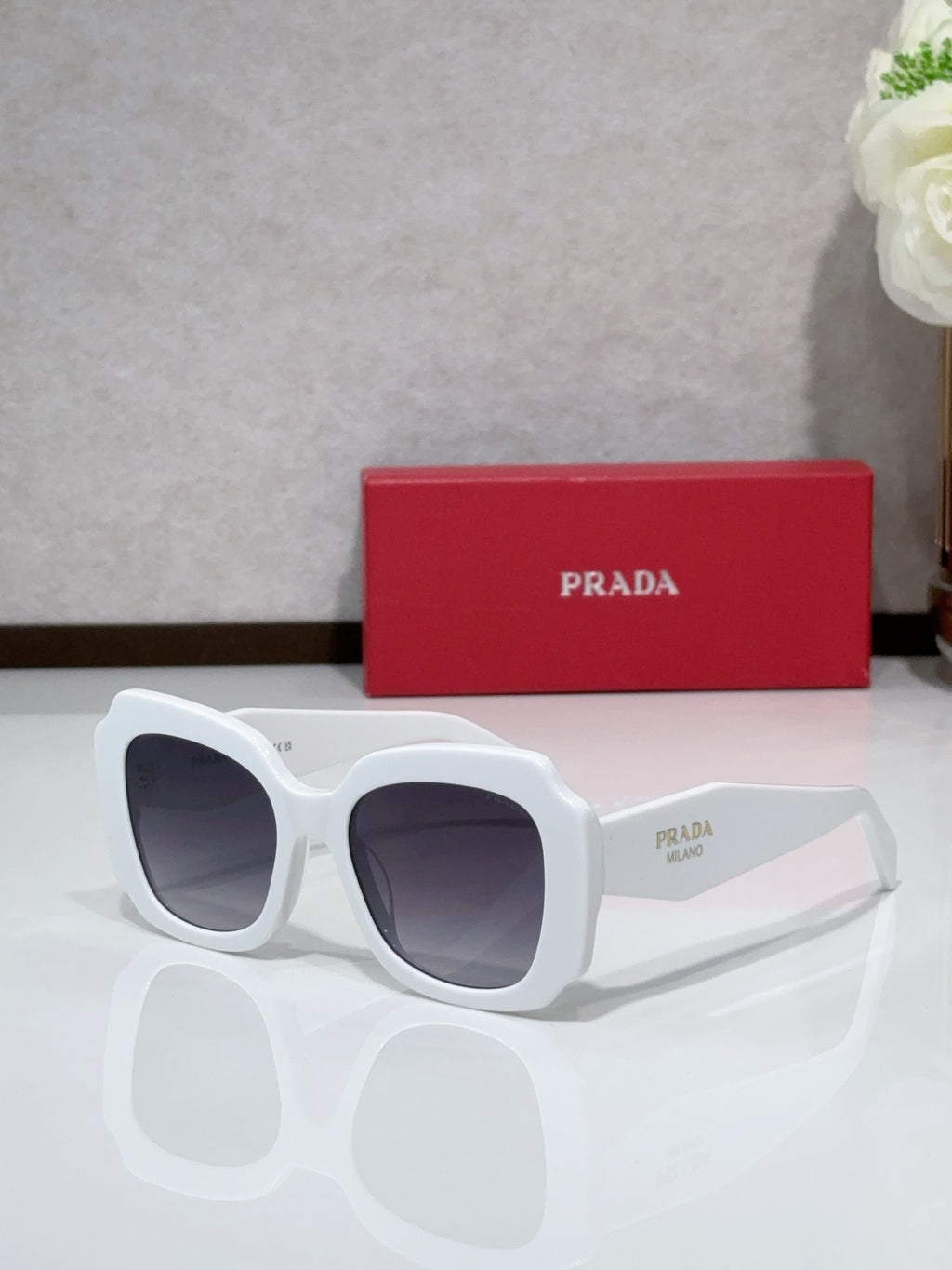 Prada sunglasses, white frame with dark tinted lenses