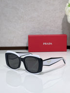 Prada sunglasses, black frame with white temples and dark tinted lenses