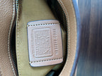 Coah bag interior label on beige patch with embossed text