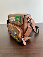 Coah bag with flap, brown patterned finish, Snoopy and character patches