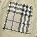 Plaid patch pocket area on beige pants with black and blue check