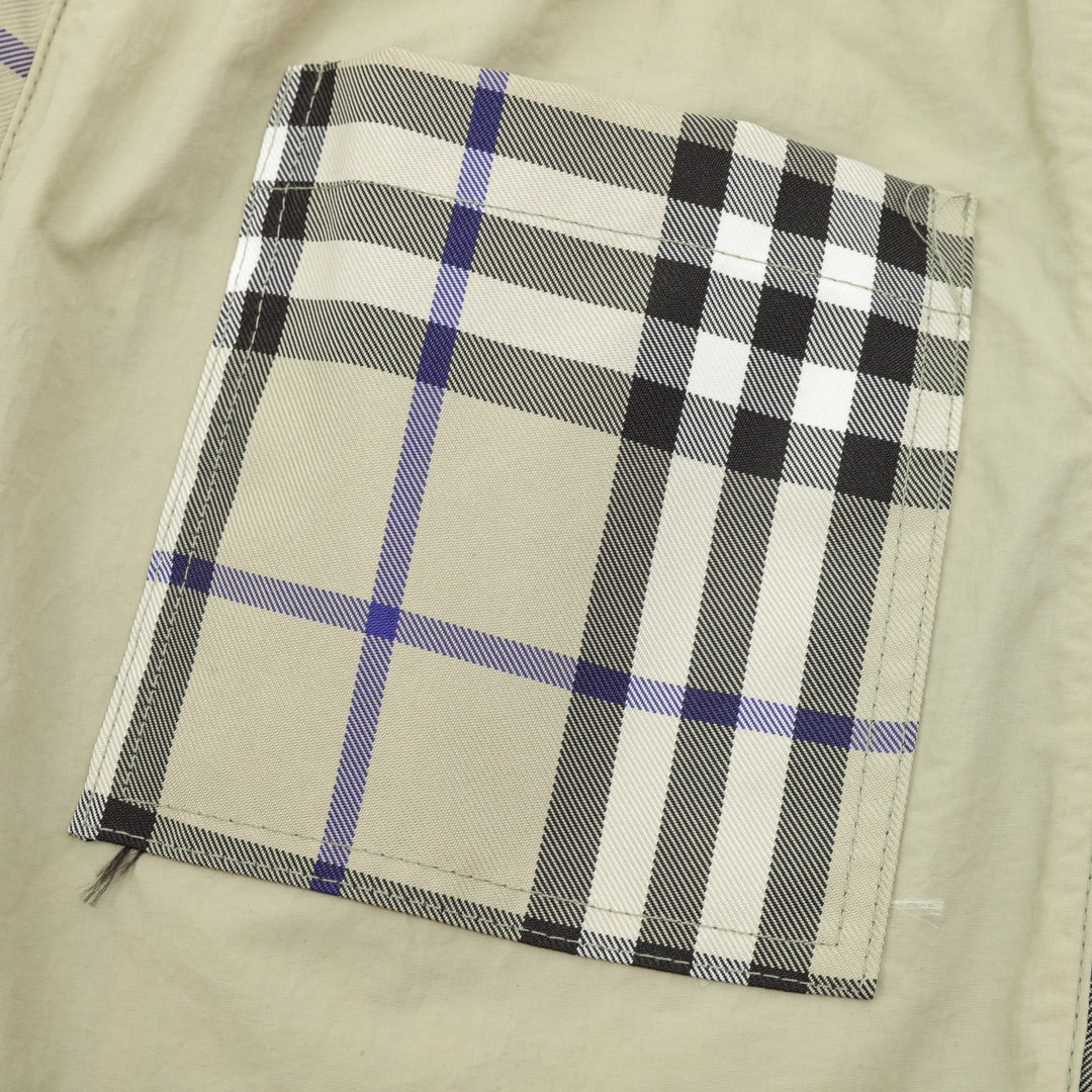 Plaid patch pocket area on beige pants with black and blue check
