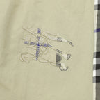 Beige pants with embroidered animal-style graphic on the front panel