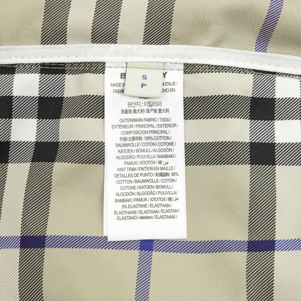 Plaid pants inner care label with fabric and composition text