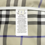 Plaid pants inner care label with fabric and composition text