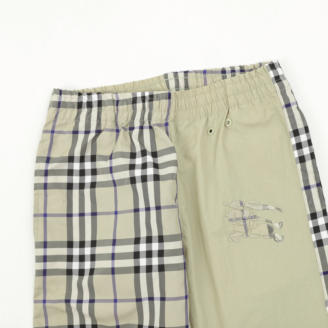 Elastic-waist pants with plaid side panel and solid front, button detail