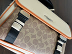 Interior front panel of beige crossbody bag with patterned fabric and buckled straps