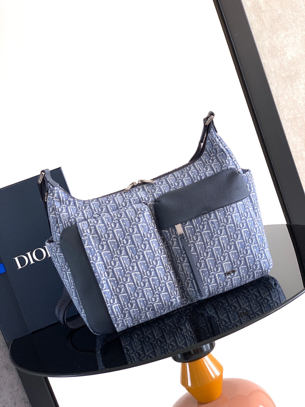 Dior men’s bag in light blue and navy with woven monogram and shoulder strap