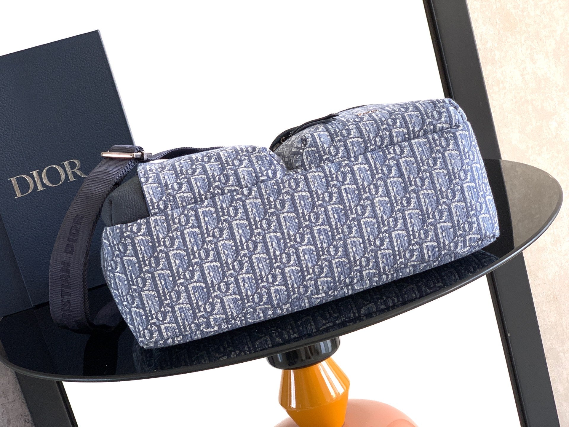 Dior duffel-style bag in light blue patterned canvas with dark blue top strap