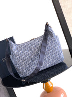 Dior men’s bag with light blue monogram canvas and navy crossbody strap