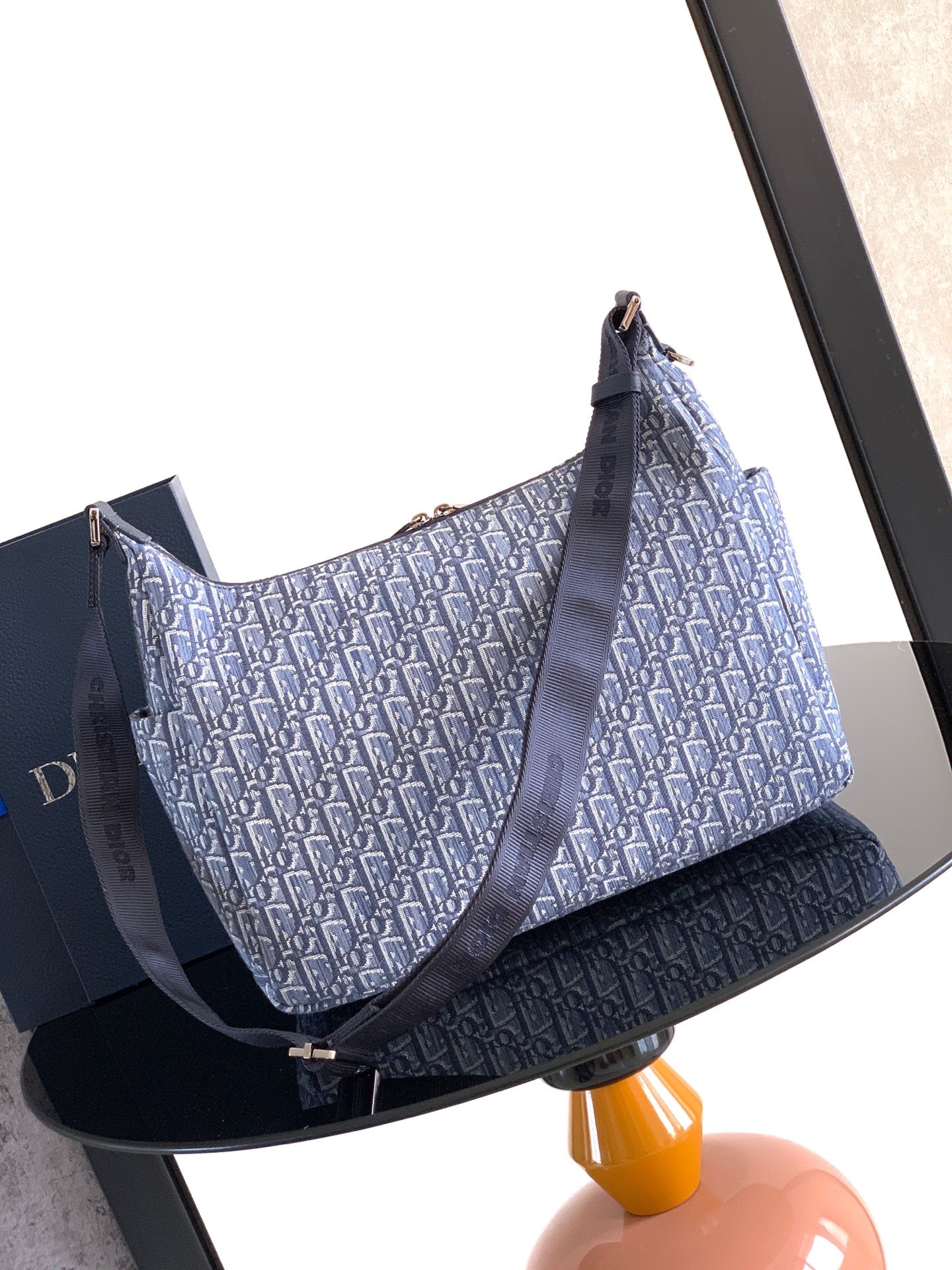 Dior men’s bag with light blue monogram canvas and navy crossbody strap