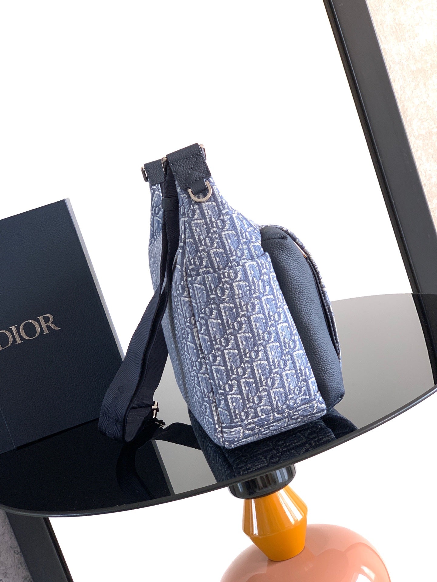 Dior men’s bag with light blue monogram canvas and navy dual straps