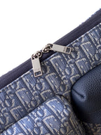 Dior strap and hardware detail on light blue monogram bag with dark blue trim