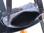 Dior men’s bag open top showing dark interior lining