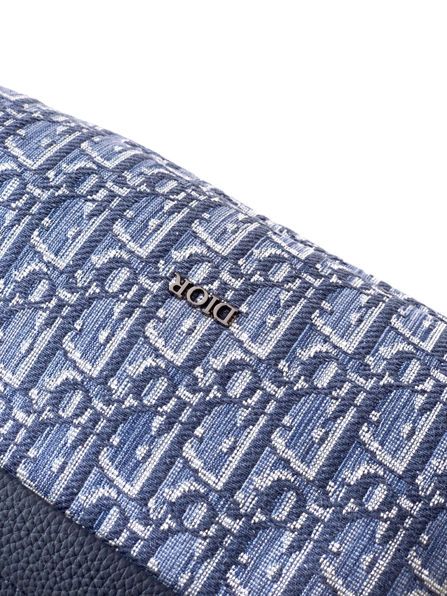 Blue Dior monogram fabric close-up with textured woven pattern and stitching