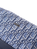 Blue Dior monogram fabric with stitched Dior detail and textured trim edge.