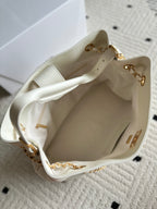 Open white Chanel quilted bag interior with gold chain detail
