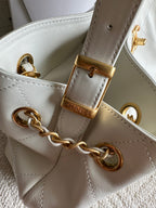 White Chanel quilted bag with gold chain, leather strap, and CHANEL hardware