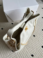 White Chanel shoulder bag with gold chain strap and CC emblem on side