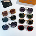 Sunglasses set on display with multiple frames and dark lenses; Louis Vuitton box in view.