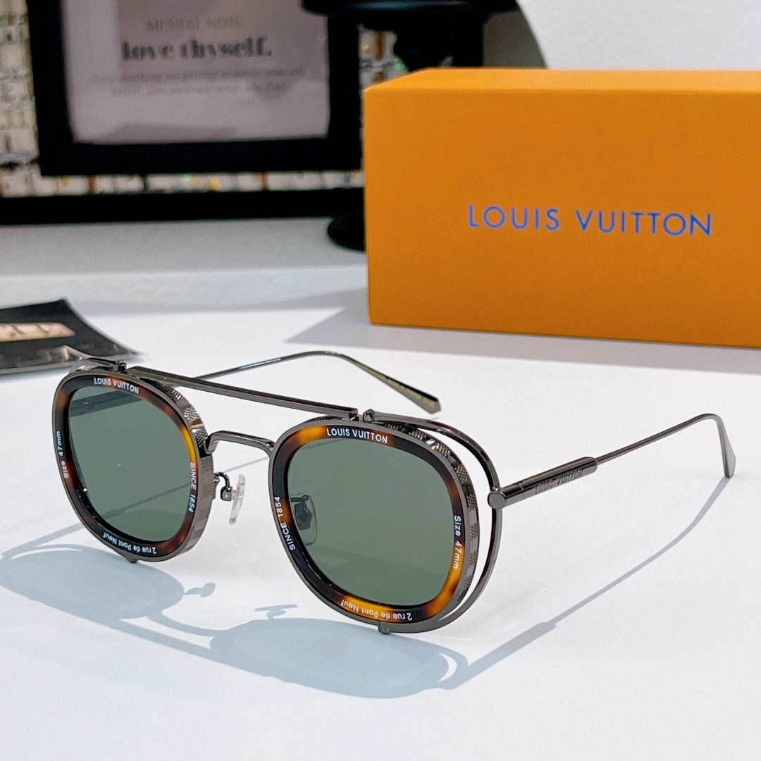 Louis Vuitton round sunglasses, silver frames with green and amber lenses.