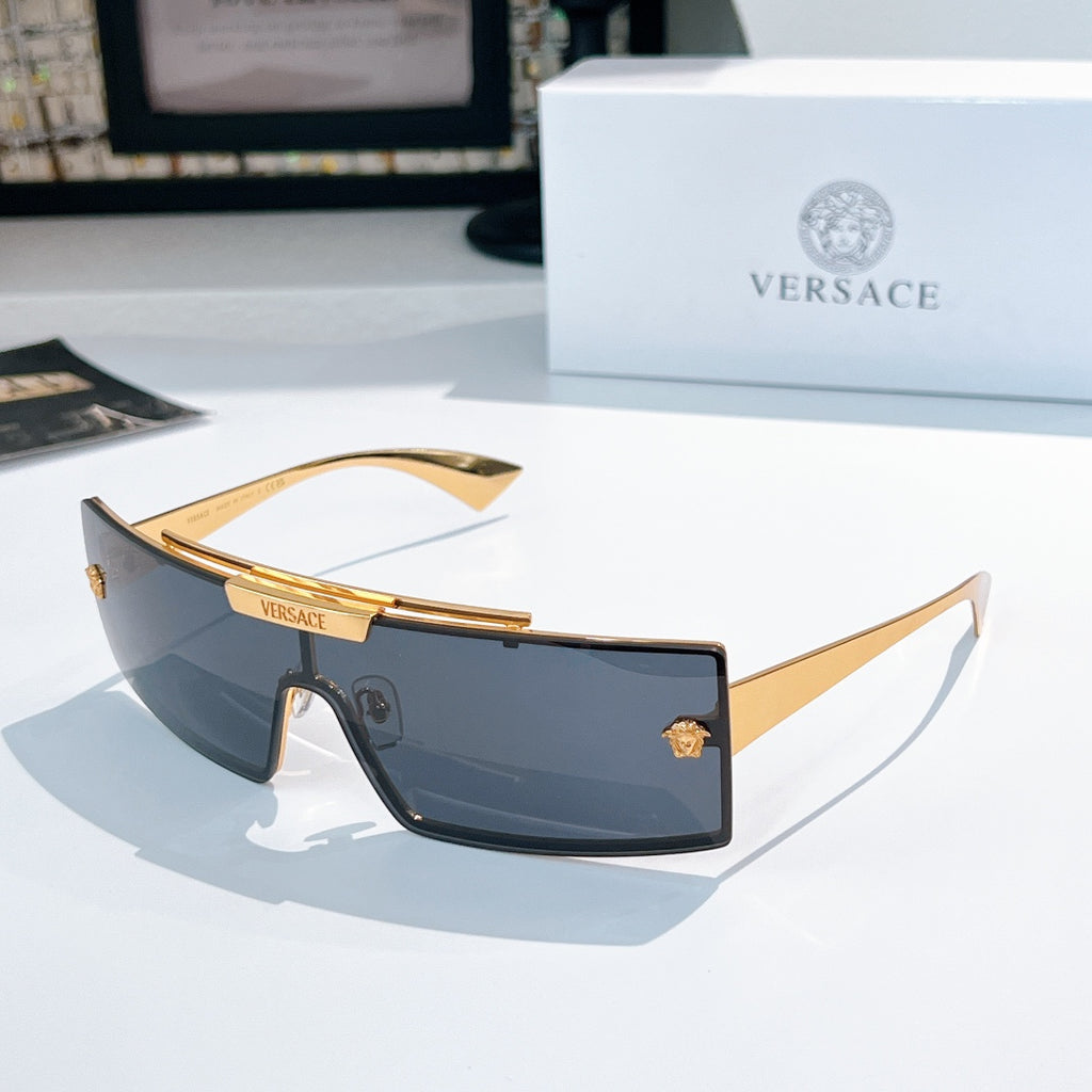 Versace sunglasses with dark tinted lenses and gold frames