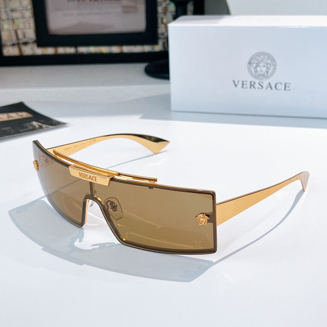 Versace sunglasses with amber tinted lenses and gold frames