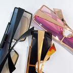 Assorted tinted sunglasses with black, gold, and pink frames