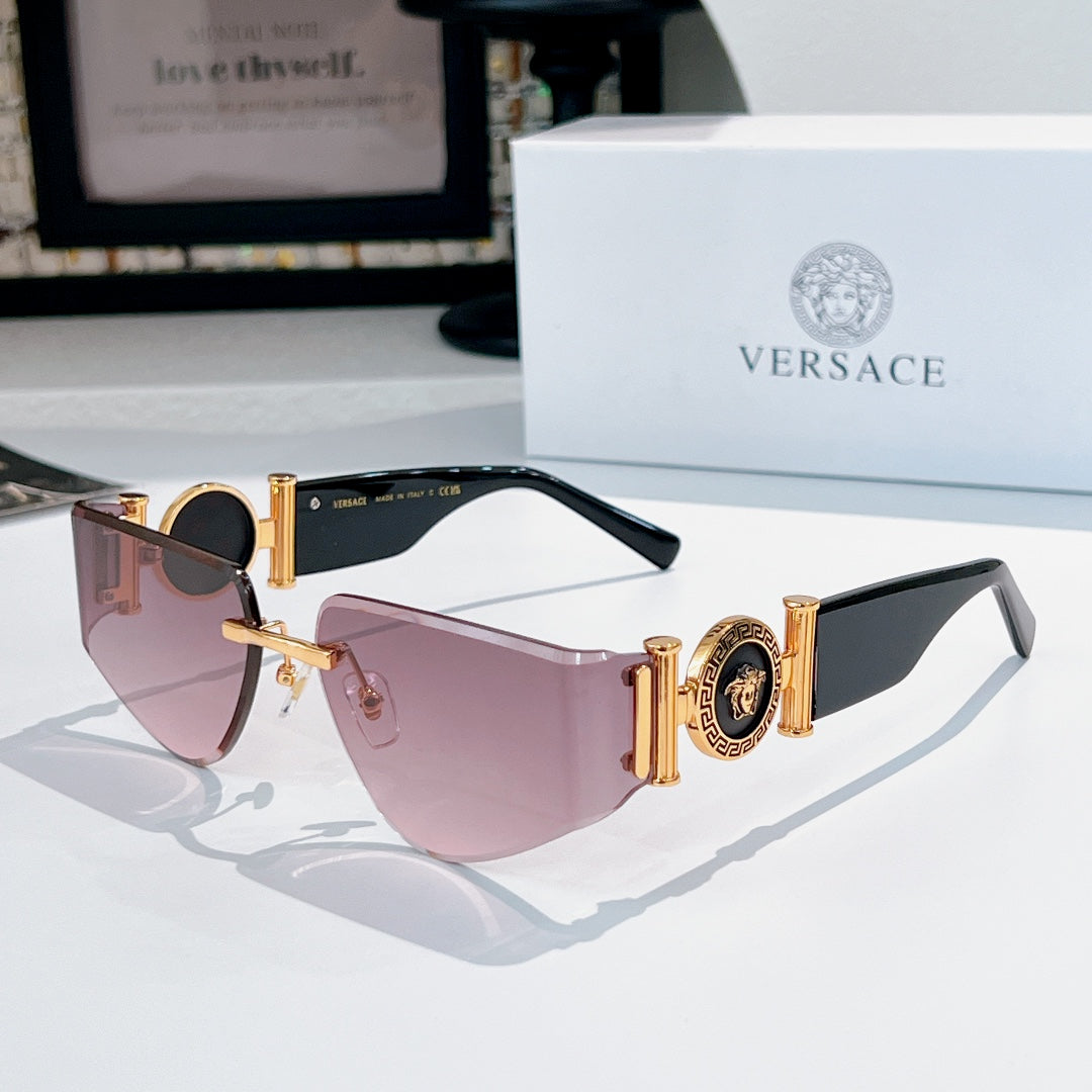 Versace sunglasses with gold accents, pink gradient lenses, and emblem detail on temples