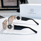 Versace sunglasses with black lenses, gold hinges, and Medusa emblem on wide temple plates