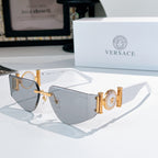 Versace sunglasses with gold frame, blue gradient lenses, and Medusa-style emblem on temples