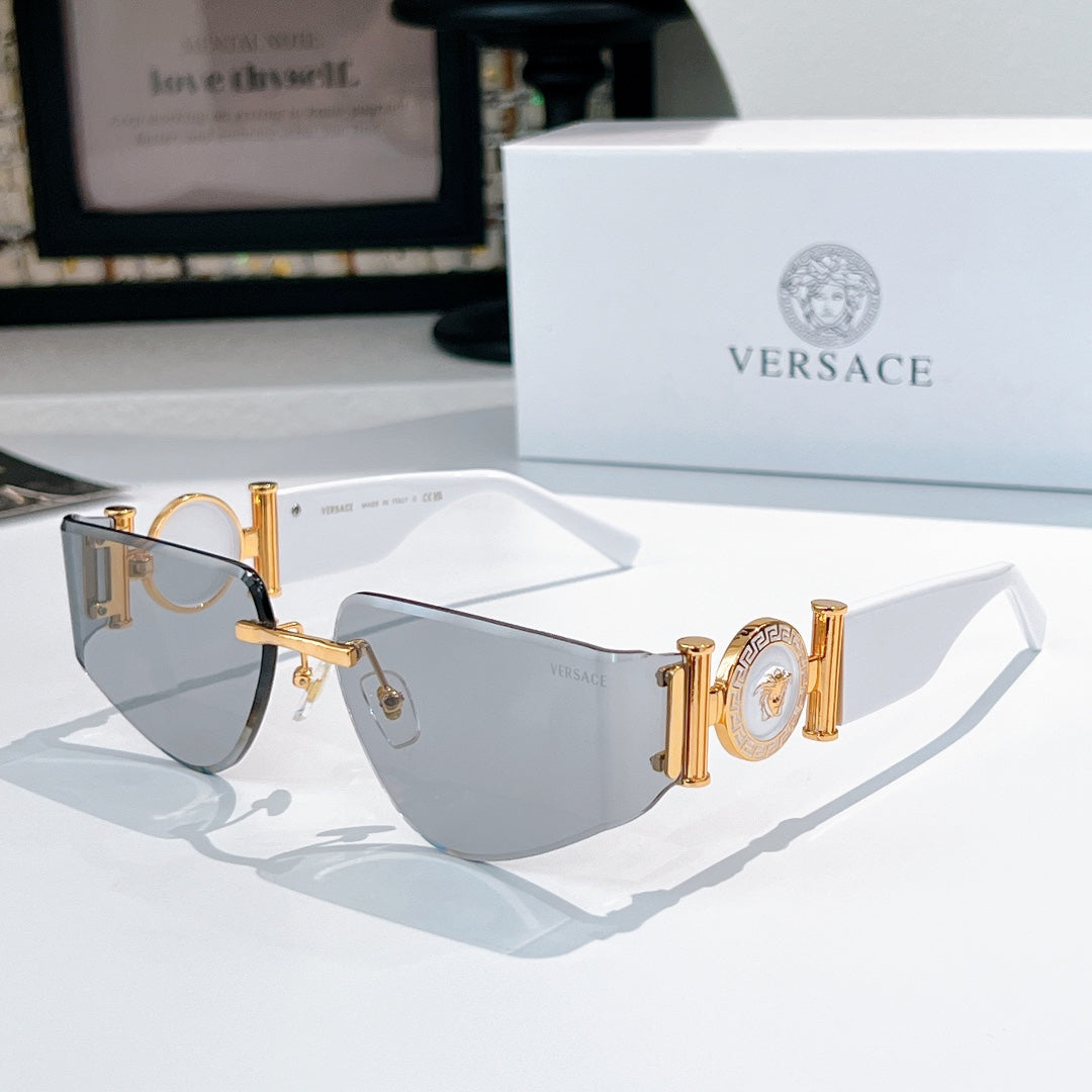 Versace sunglasses with gold frame, blue gradient lenses, and Medusa-style emblem on temples