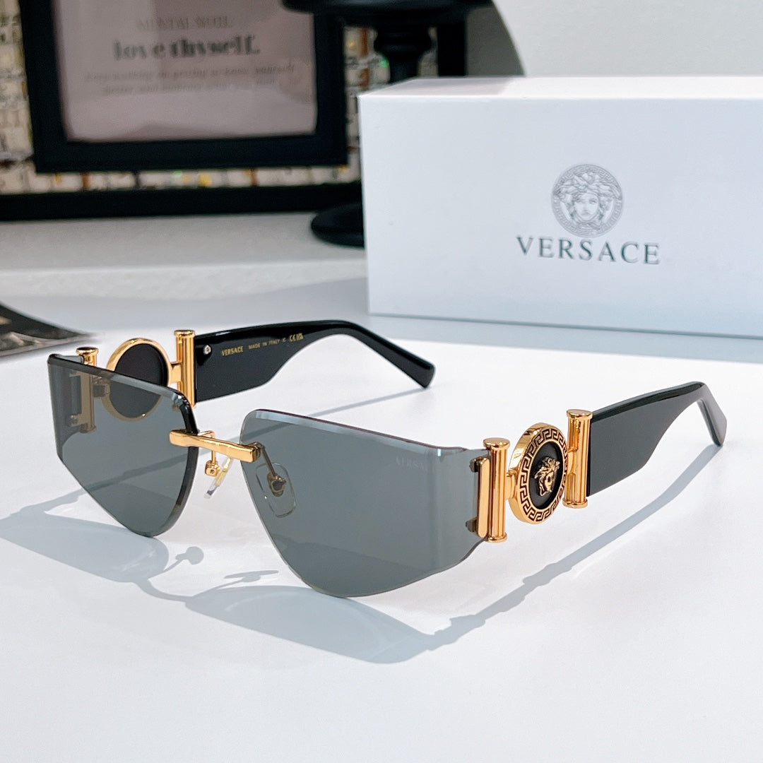 Versace sunglasses with gold frame, gray gradient lenses, and Medusa emblem on temples