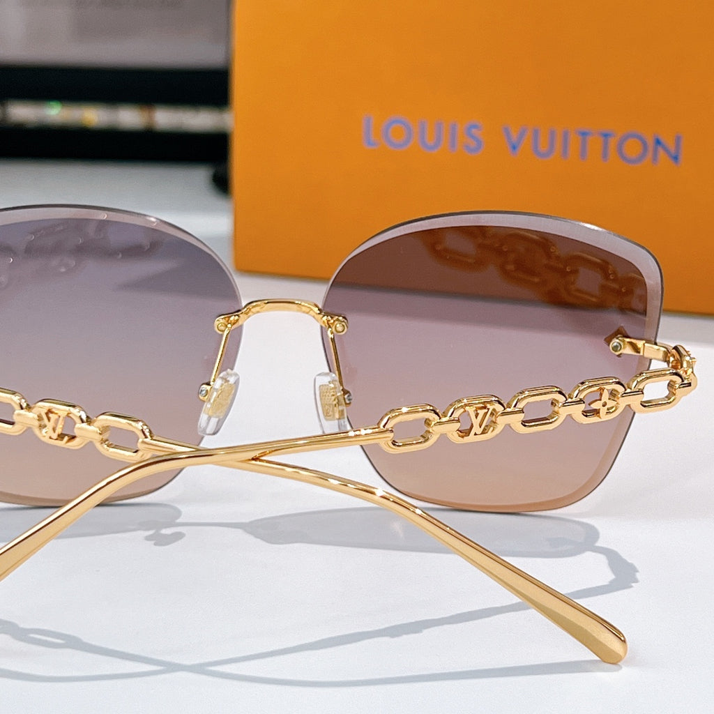 Louis Vuitton shield sunglasses with gold frames, pink tinted lenses, and chain detail