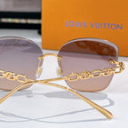 Louis Vuitton shield sunglasses with gold frames, pink tinted lenses, and chain detail