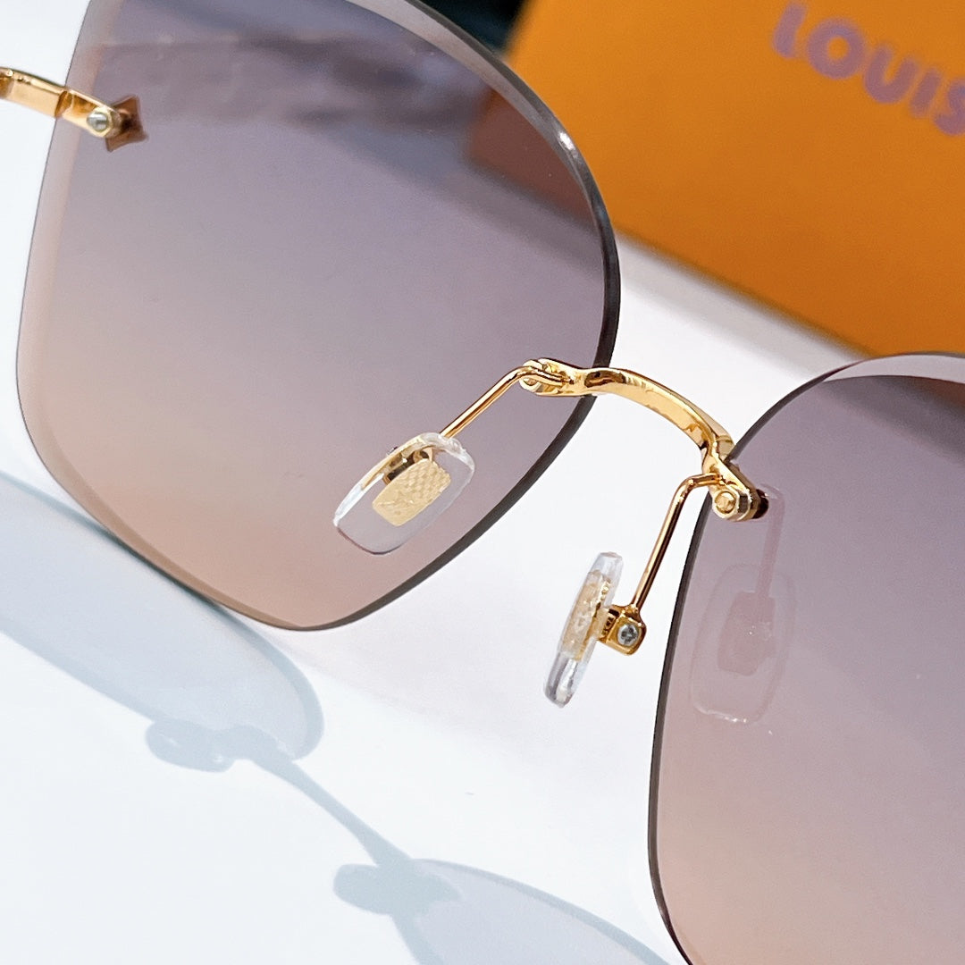 Gold frame sunglasses with pink tinted shield lenses and logo hinge detail