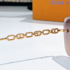 Gold chain temple sunglasses with shield frame and signature metal end pieces
