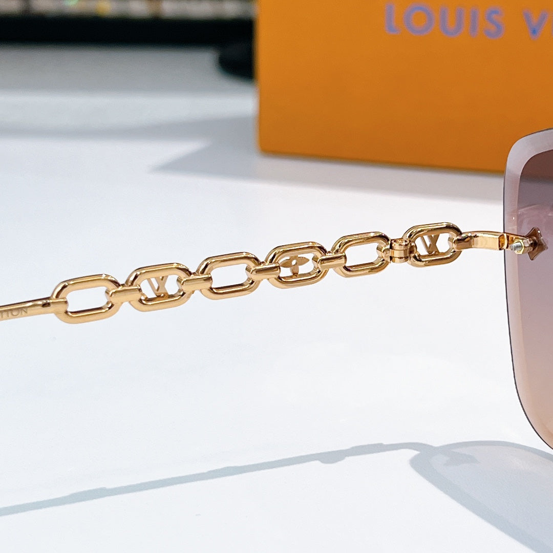 Gold chain temple sunglasses with shield frame and signature metal end pieces