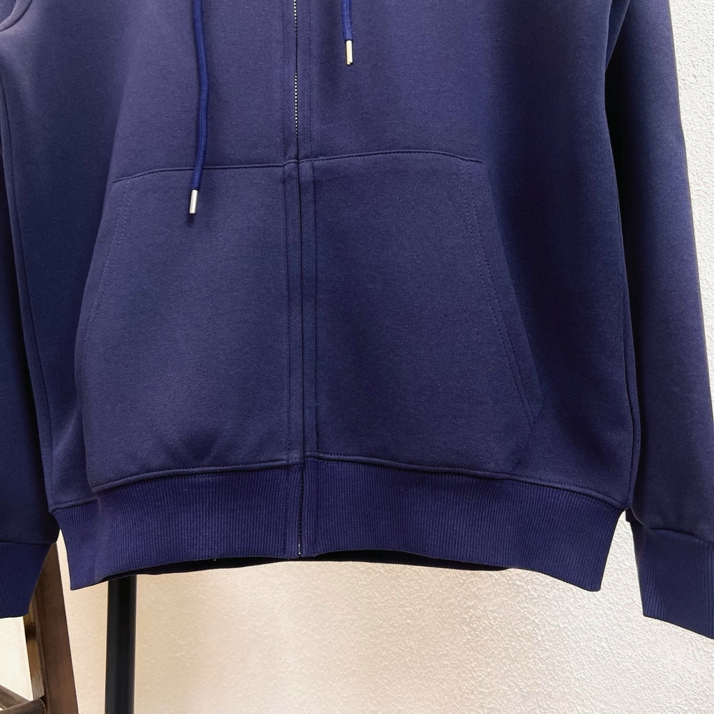 Navy zip-up hoodie close-up of front zipper and drawstrings