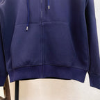 Navy zip-up hoodie close-up of front zipper and drawstrings