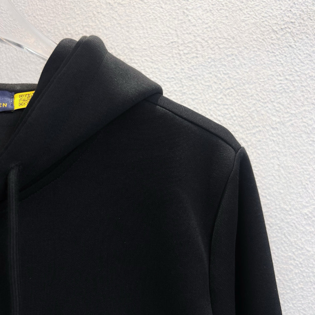 Black hoodie shoulder and hood detail, zip-up style