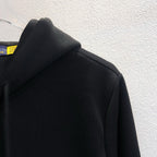 Black hoodie shoulder and hood detail, zip-up style