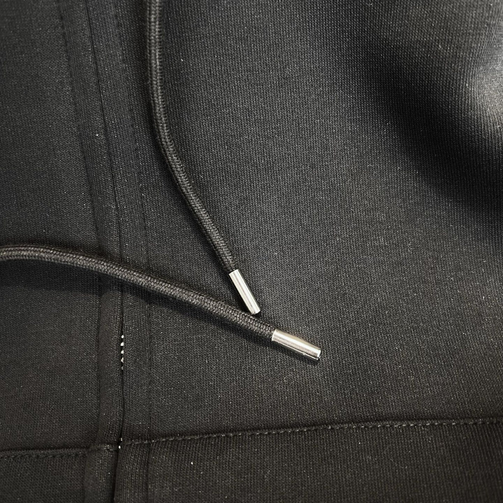 Zip-up hoodie close-up showing zipper track and metal zipper pull