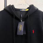 Black zip-up hoodie with red polo logo and hood drawstrings